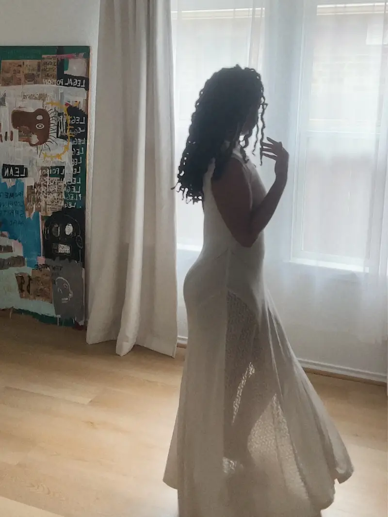 woman in off white sleeveless sheer maxi dress