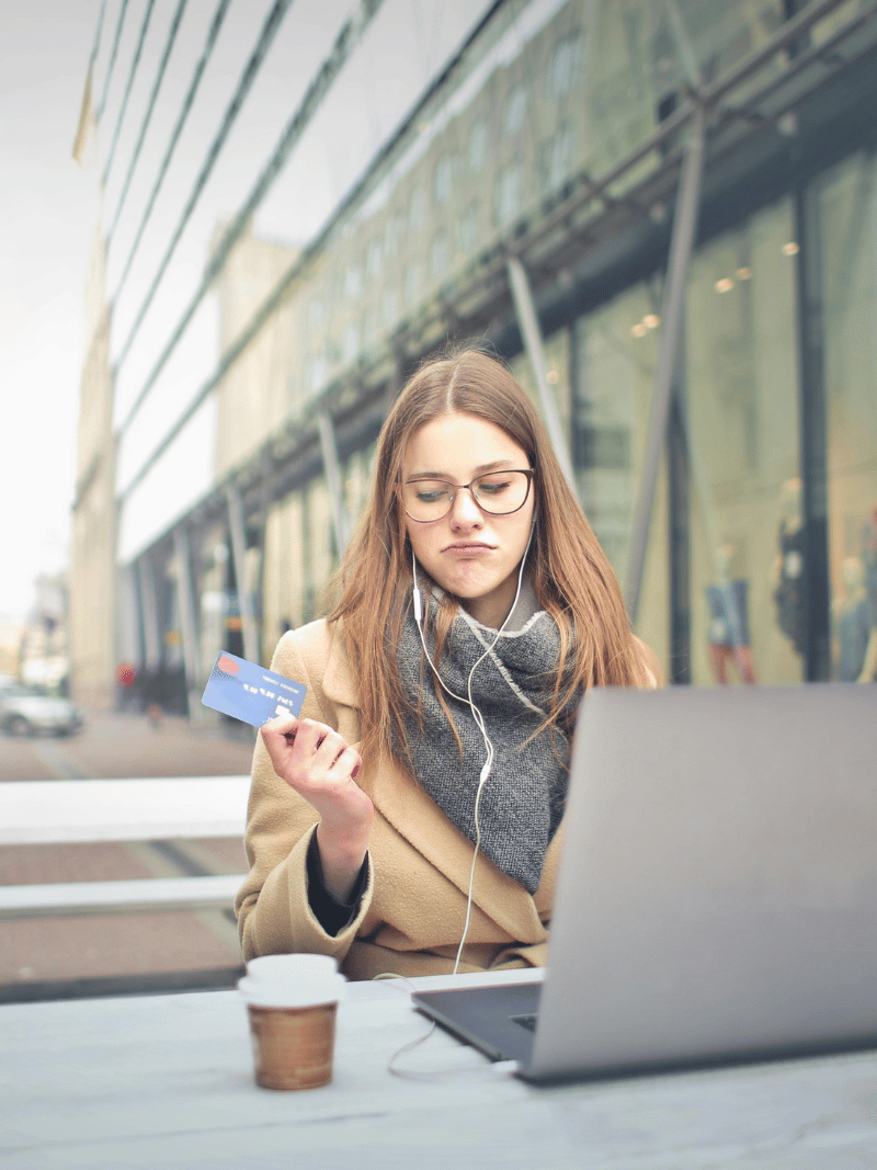 woman debating buying something online with her credit card