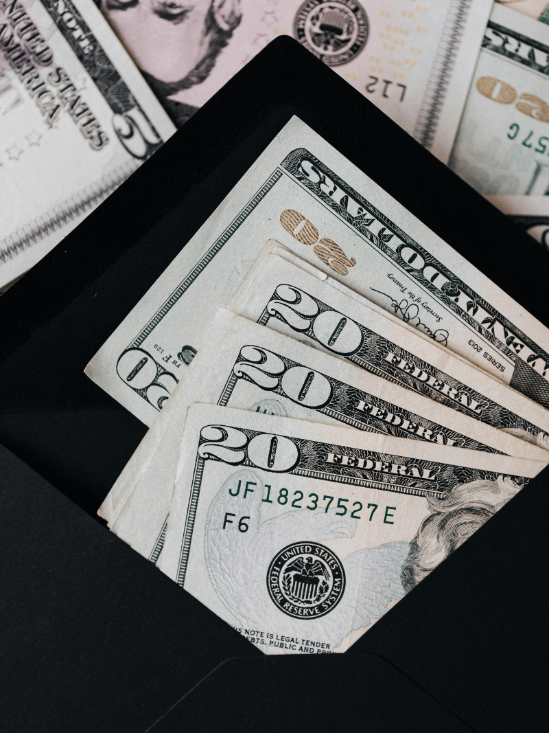 twenty dollar bills in a black envelope