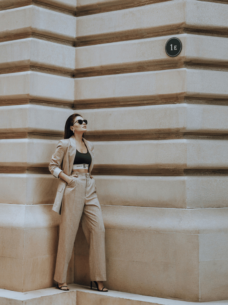 confident woman in a beige suit with a crop top