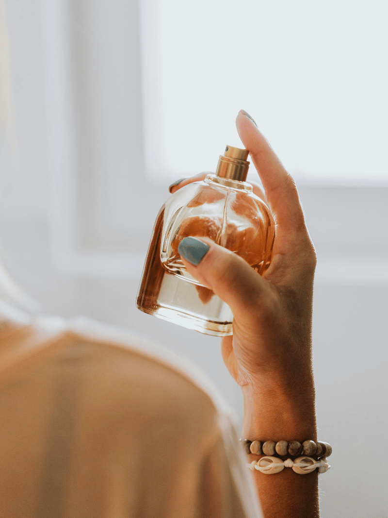 woman spraying perfume