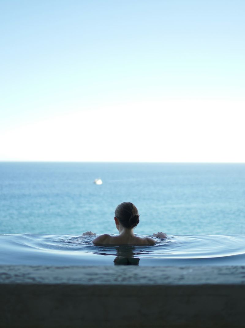 woman relaxing in an infinity pool