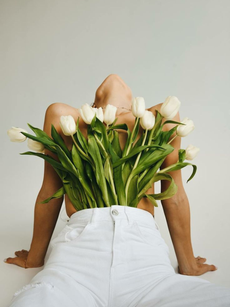woman with spring flowers white tulips