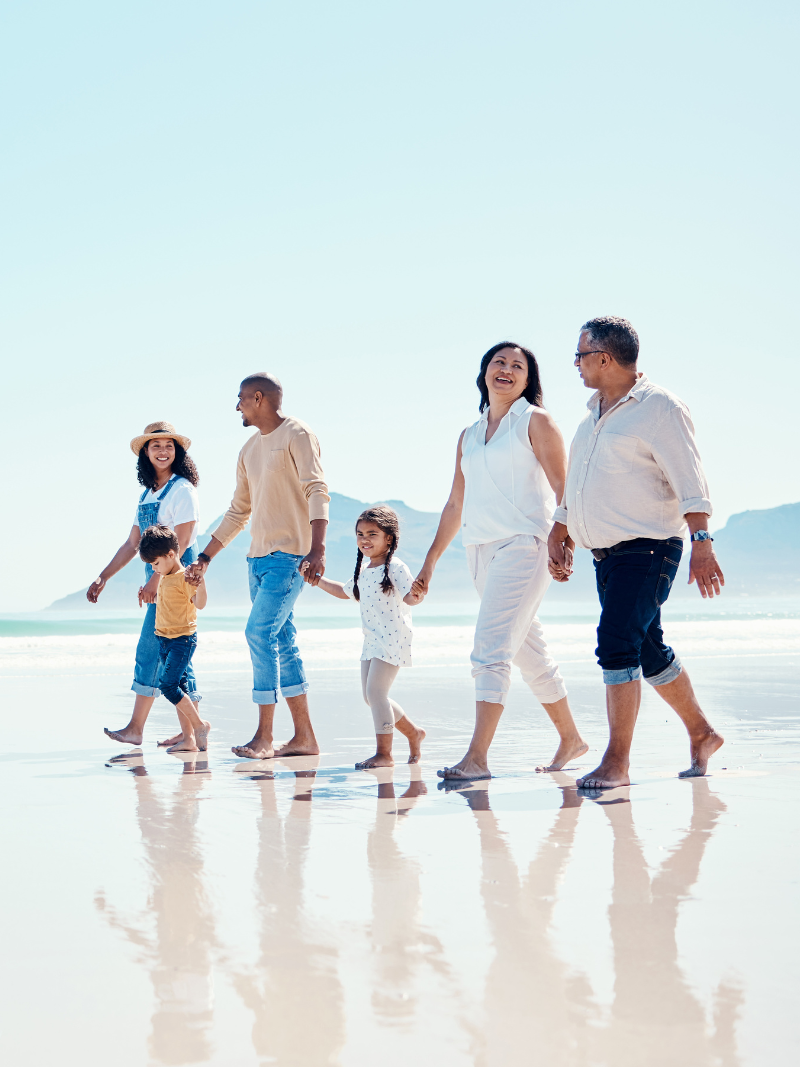 multigenerational family walking on the beach